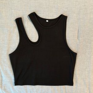 Black crop top featuring cutout on right shoulder.